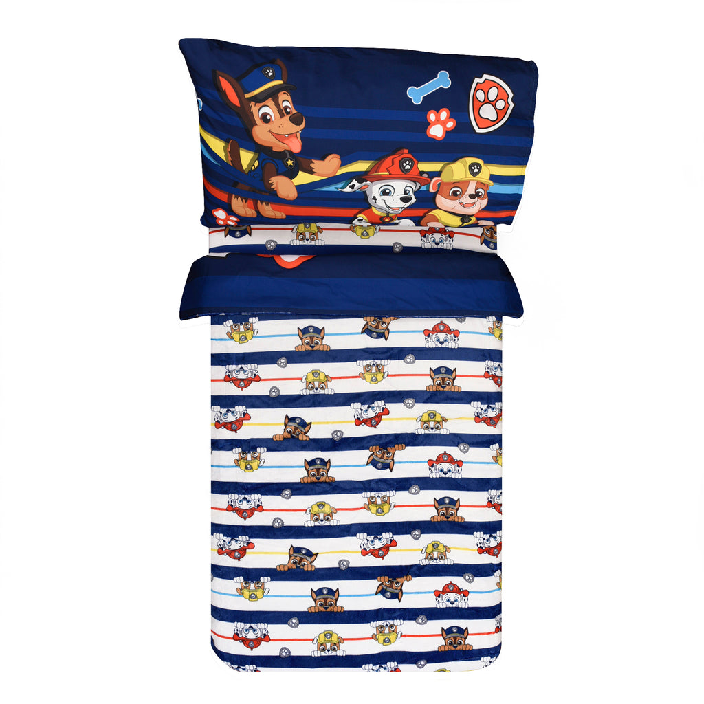 Paw Patrol Toddler Bedding Set reversed comforter on a bed on white background